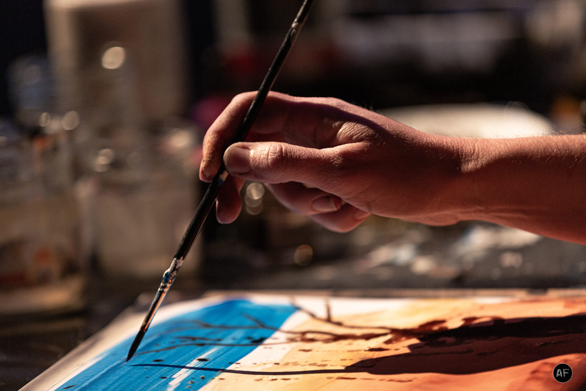 une main fait de la peinture au rythme de la musique
